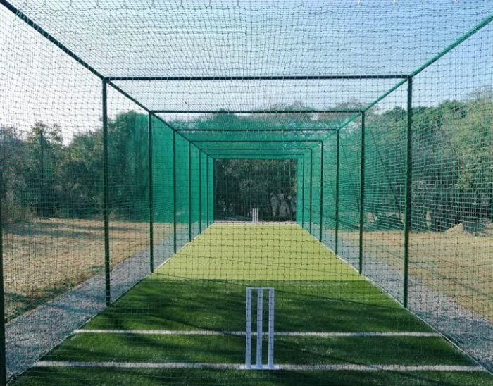 NineCourts cricket net interior view showing playing strip, stumps and netted enclosure