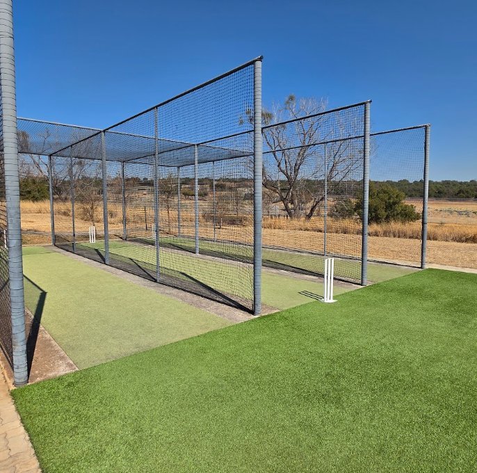 NineCourts outdoor cricket practice net installation with prepared base and turf surface