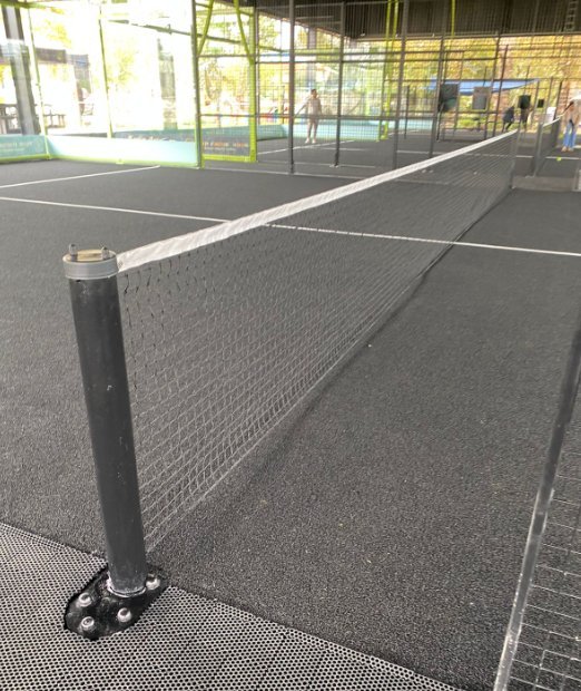 Padel court Astro Turf surface with net post detail at a NineCourts installation