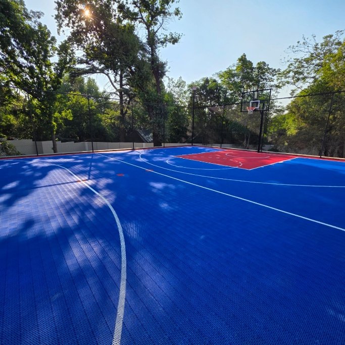 InterLock Tile multi-purpose court — finished installation in a tree-lined garden setting