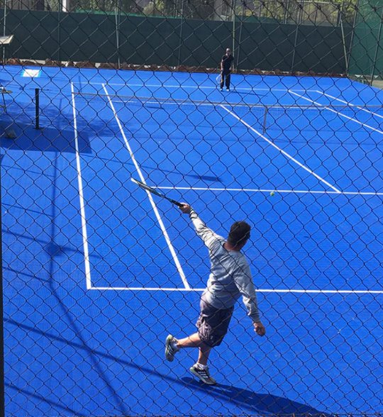 Tennis player in action on a NineCourts InterLock Tile court