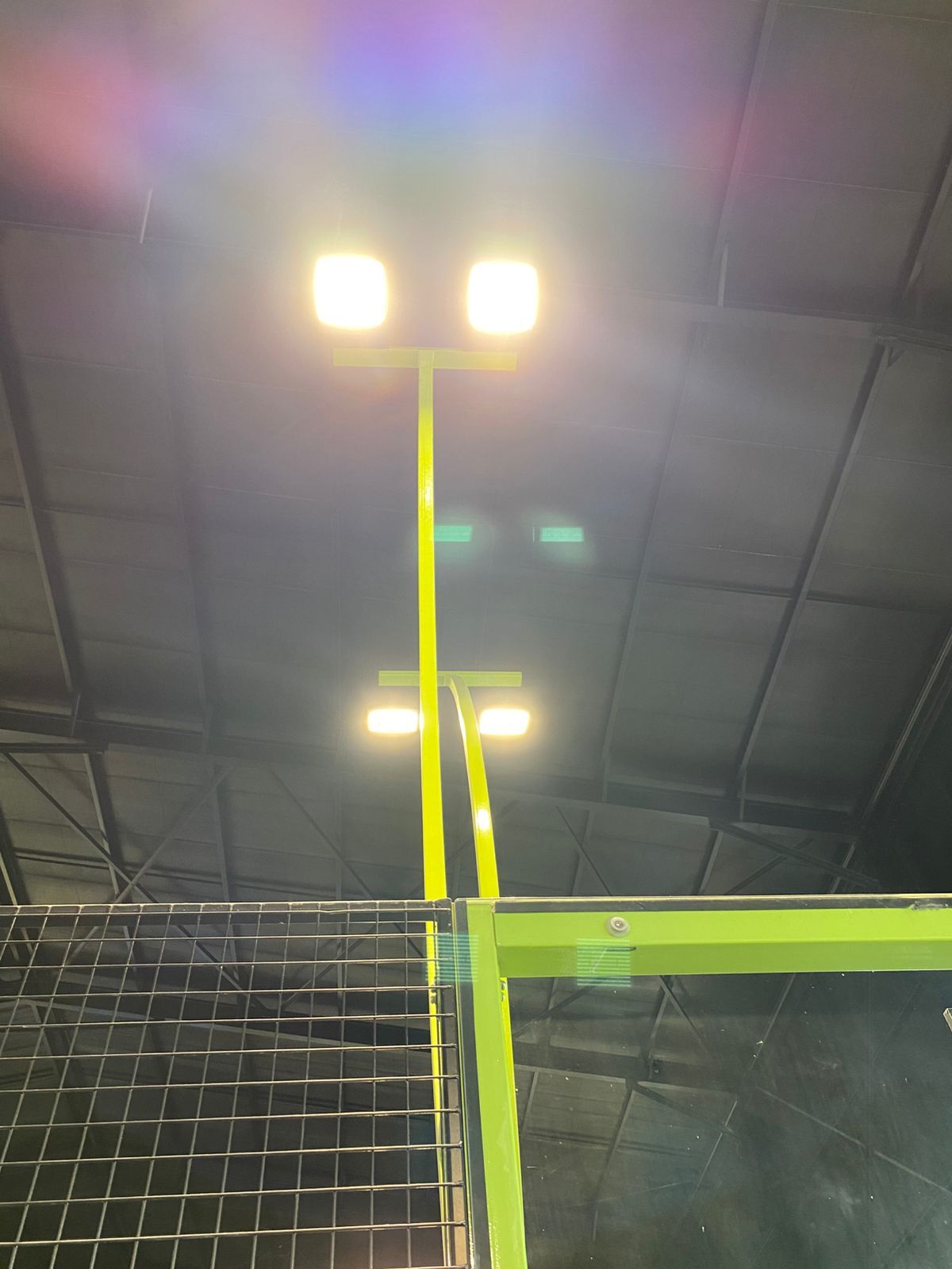 NineCourts padel court lit by overhead floodlights for evening play