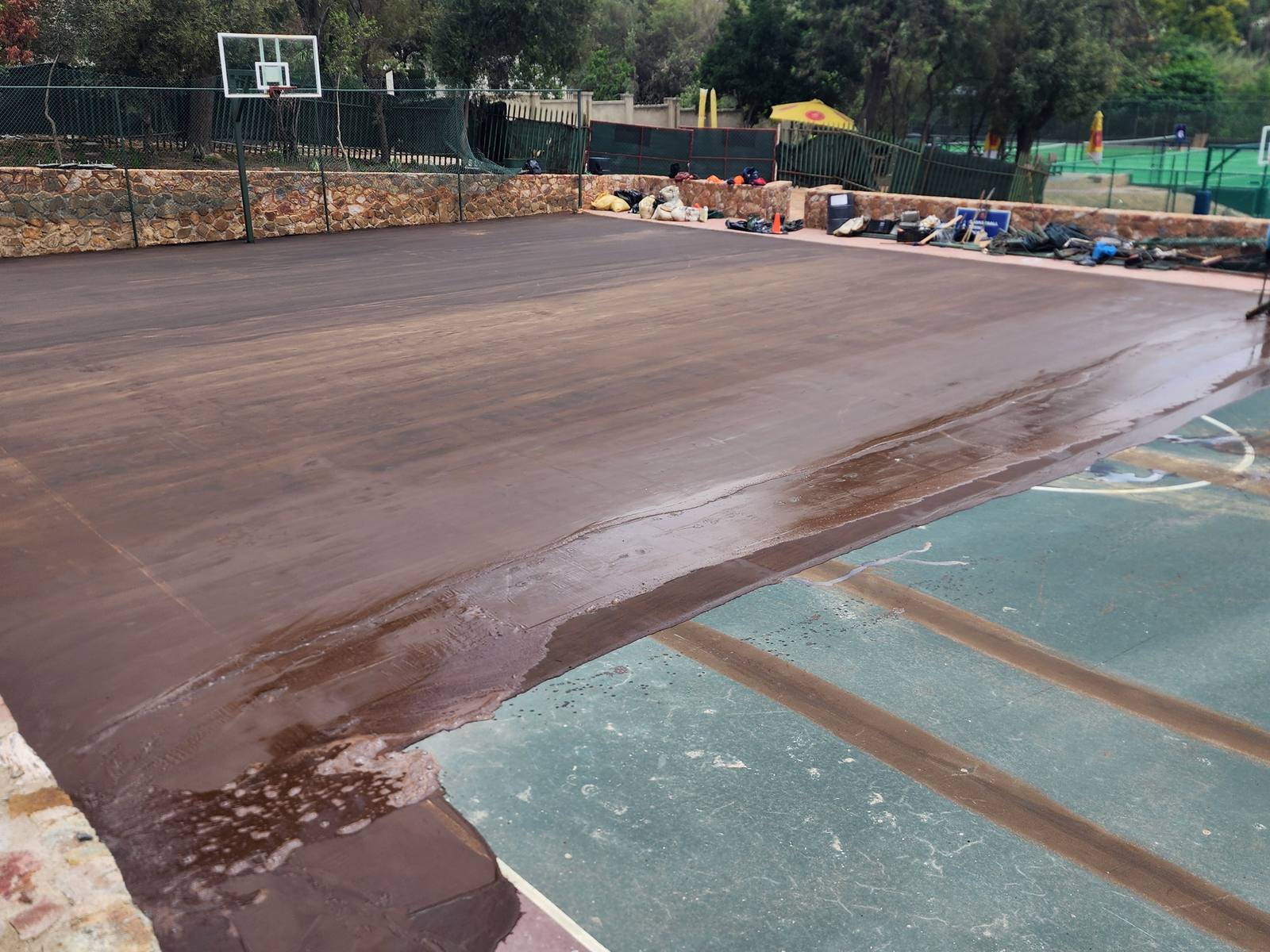 St. Peters basketball court mid-resurfacing — base coat application